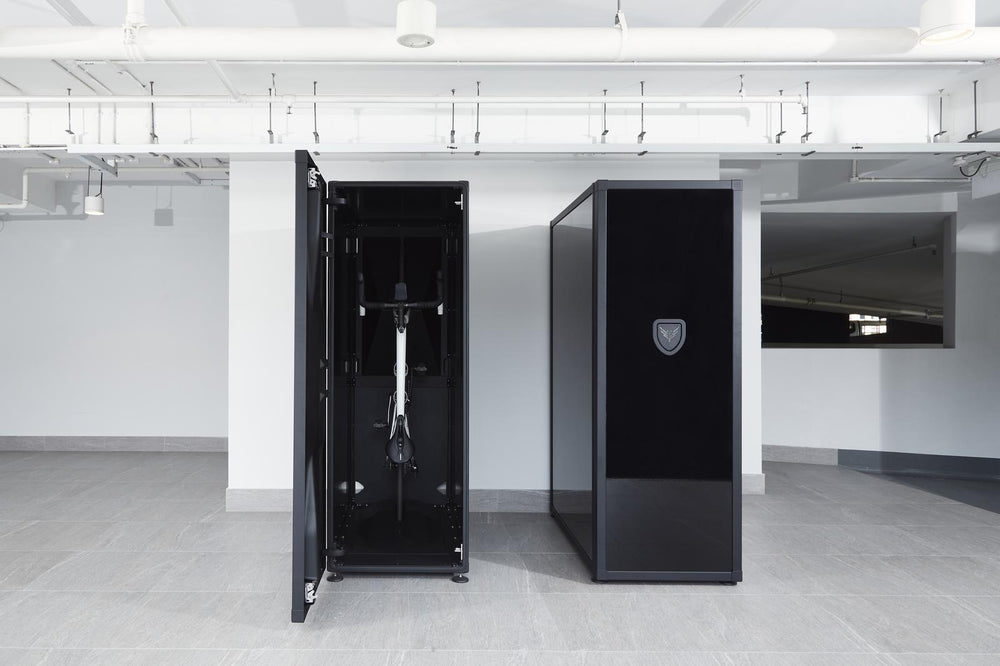 Black safe deposit box with a bike inside in a modern indoor setting