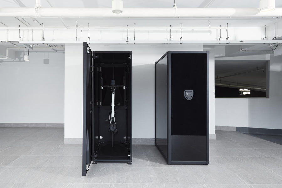 Black safe deposit box with a bike inside in a modern indoor setting