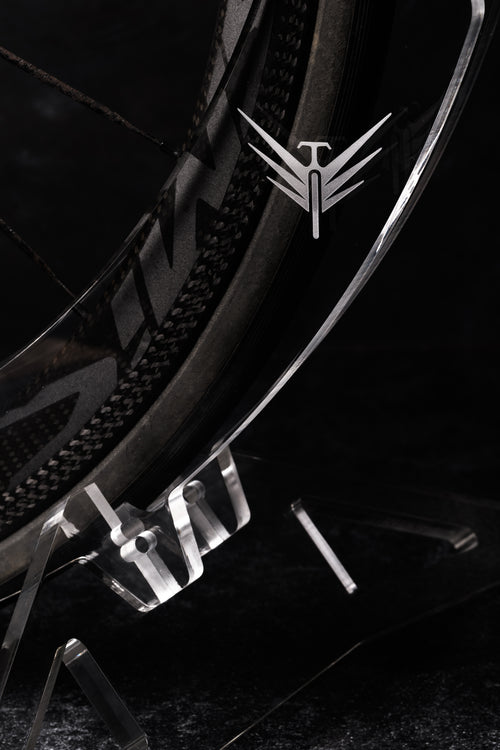Close-up of a Velohawk Luna bike Stand with a logo on a dark background